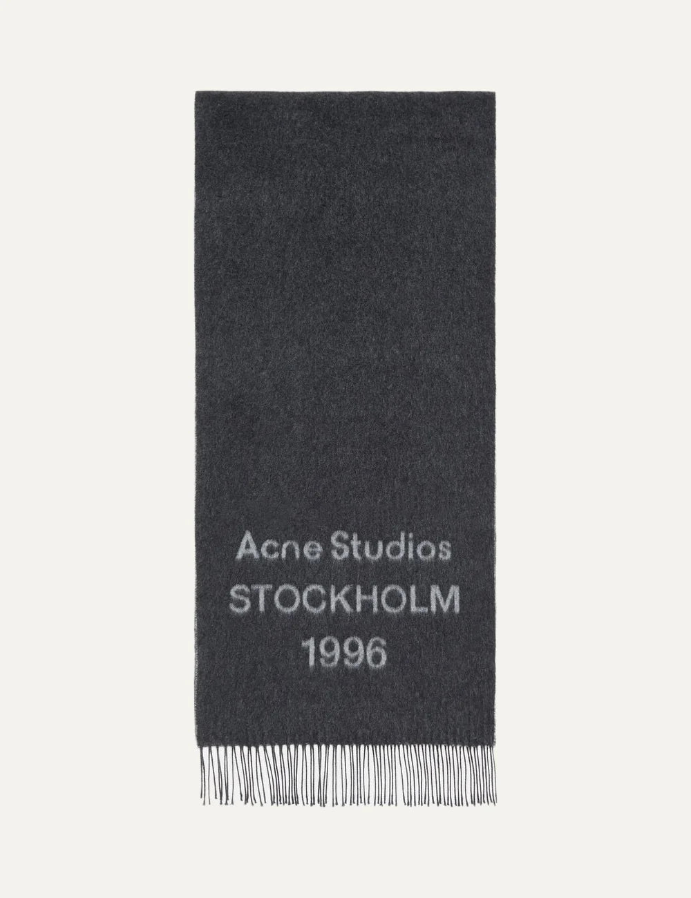 Acne Studios men's dark charcoal grey wool jacquard scarf featuring contrasting Acne Studios Stockholm 1996 logo lettering and fringed ends.