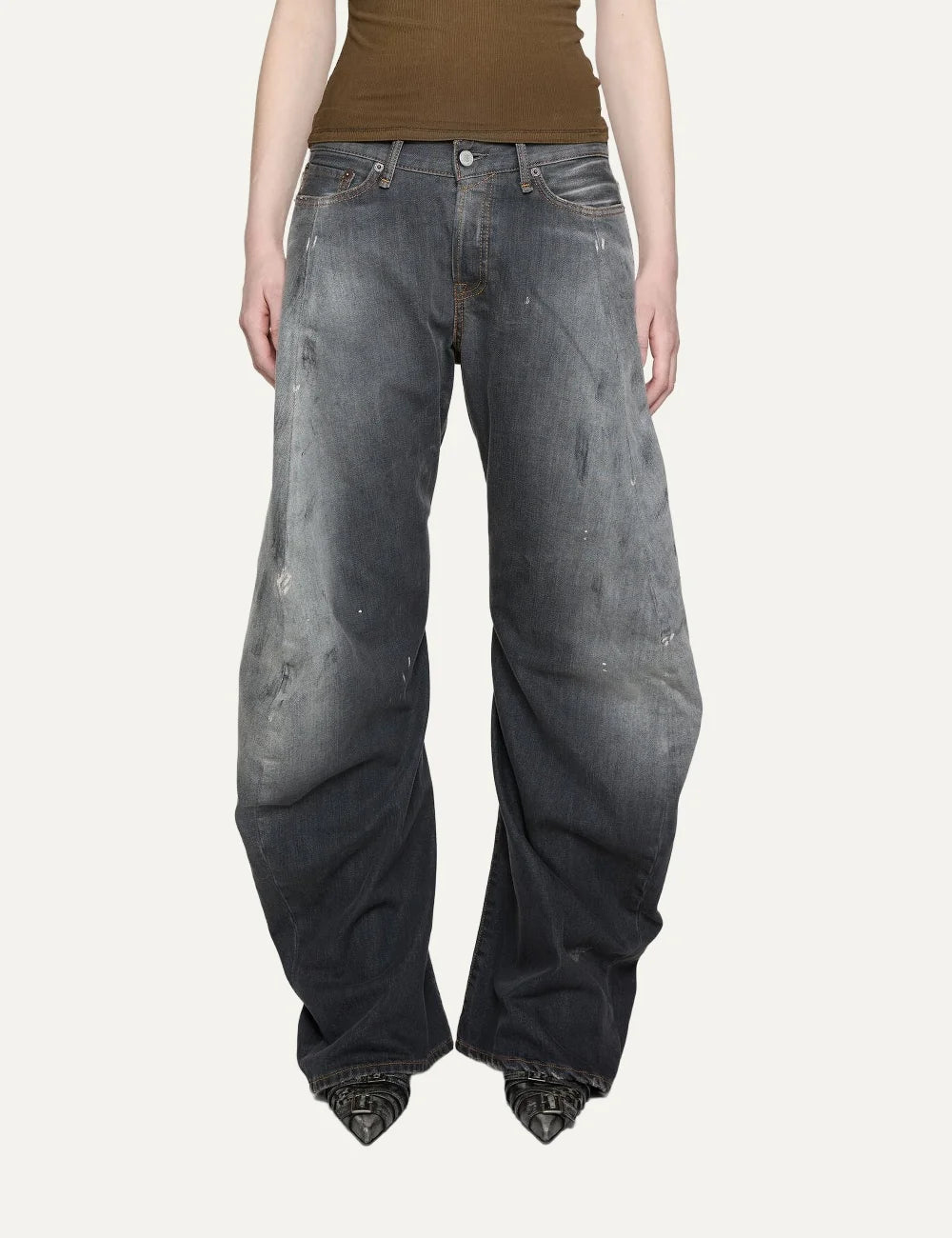 Acne Studios women's 2006F Black Trafalgar jeans in faded black denim with a dirty wash, hand-applied paint splatters, low waist, loose fit and extra-long wide legs model