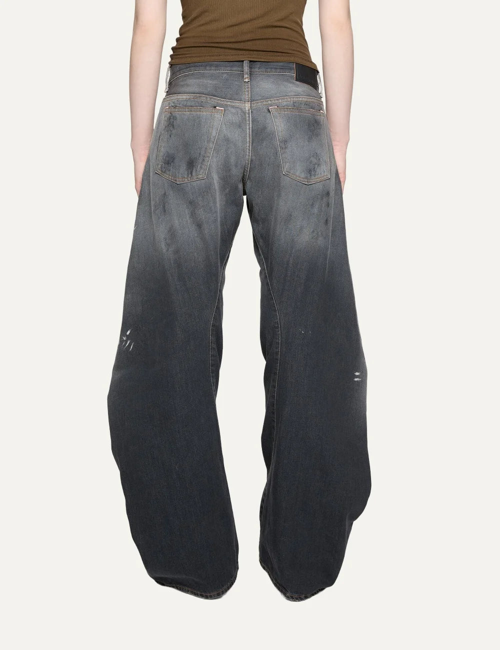 Acne Studios women's 2006F Black Trafalgar jeans in faded black denim with a dirty wash, hand-applied paint splatters, low waist, loose fit and extra-long wide legs back