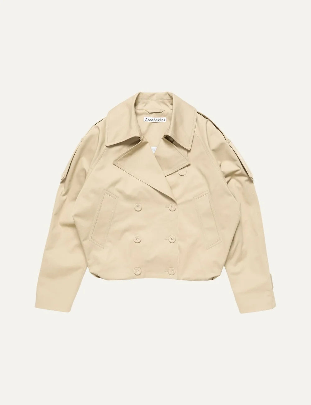 Acne Studios women's beige cropped cotton twill trench coat with oversized lapels, double-breasted button closure, shoulder epaulettes, relaxed fit and gathered balloon hem.
