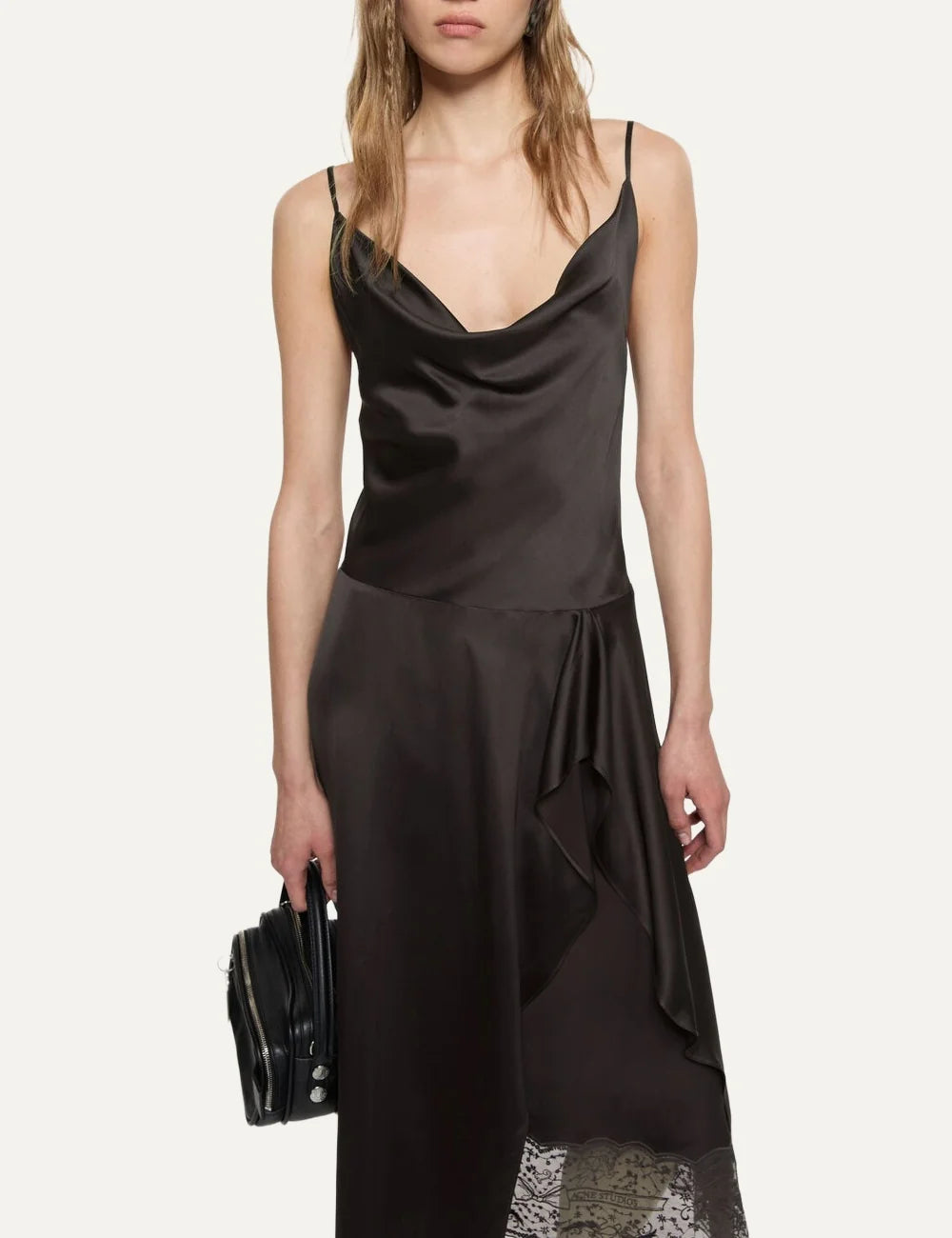 Acne Studios women's dark brown satin midi slip dress with a draped cowl neckline, adjustable spaghetti straps, front ruffled slit and delicate dark brown lace underlayer model