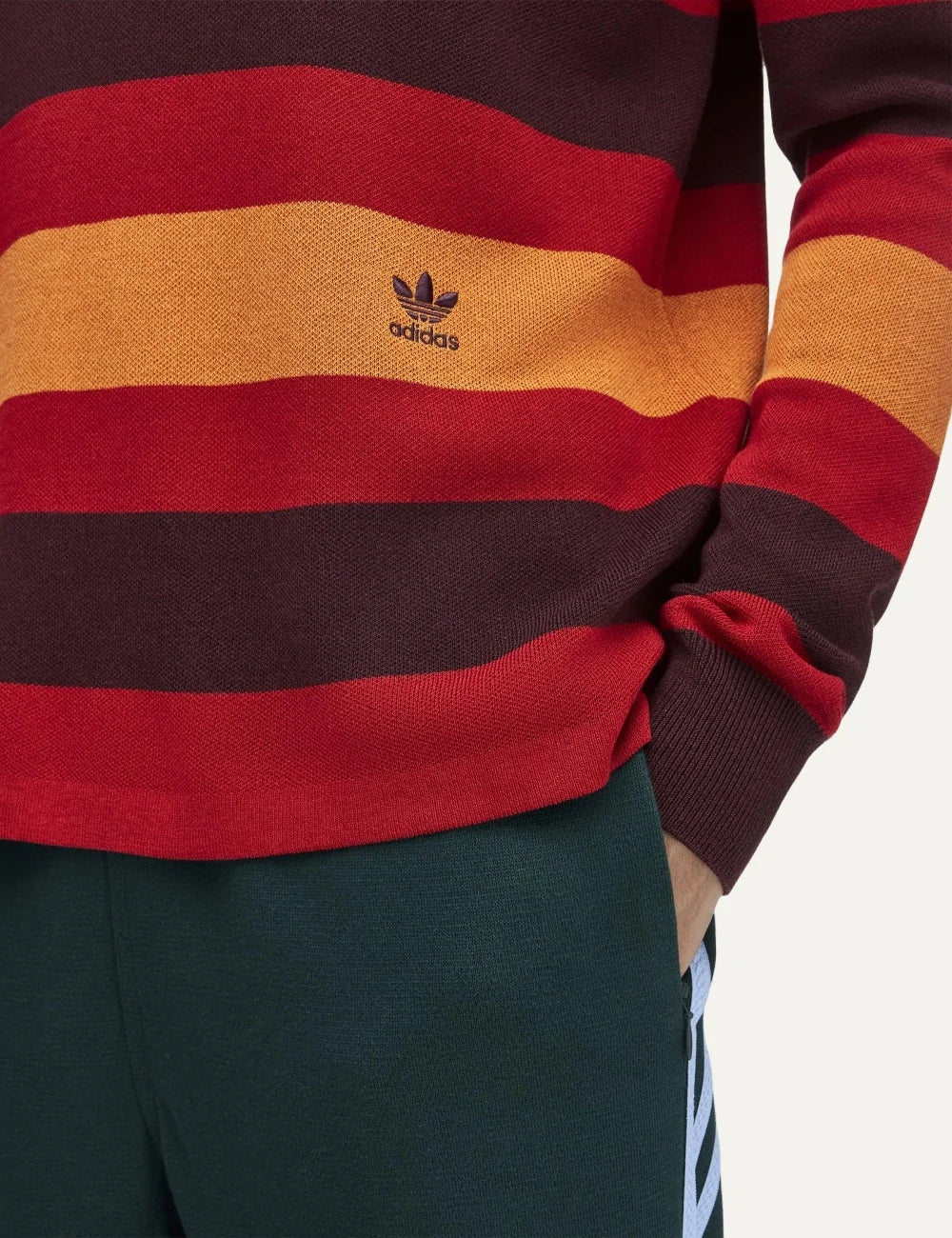 Adidas Originals x Wales Bonner men's striped knit sweater in burgundy, red and orange with layered collar, long sleeves and small Trefoil logo. close up view