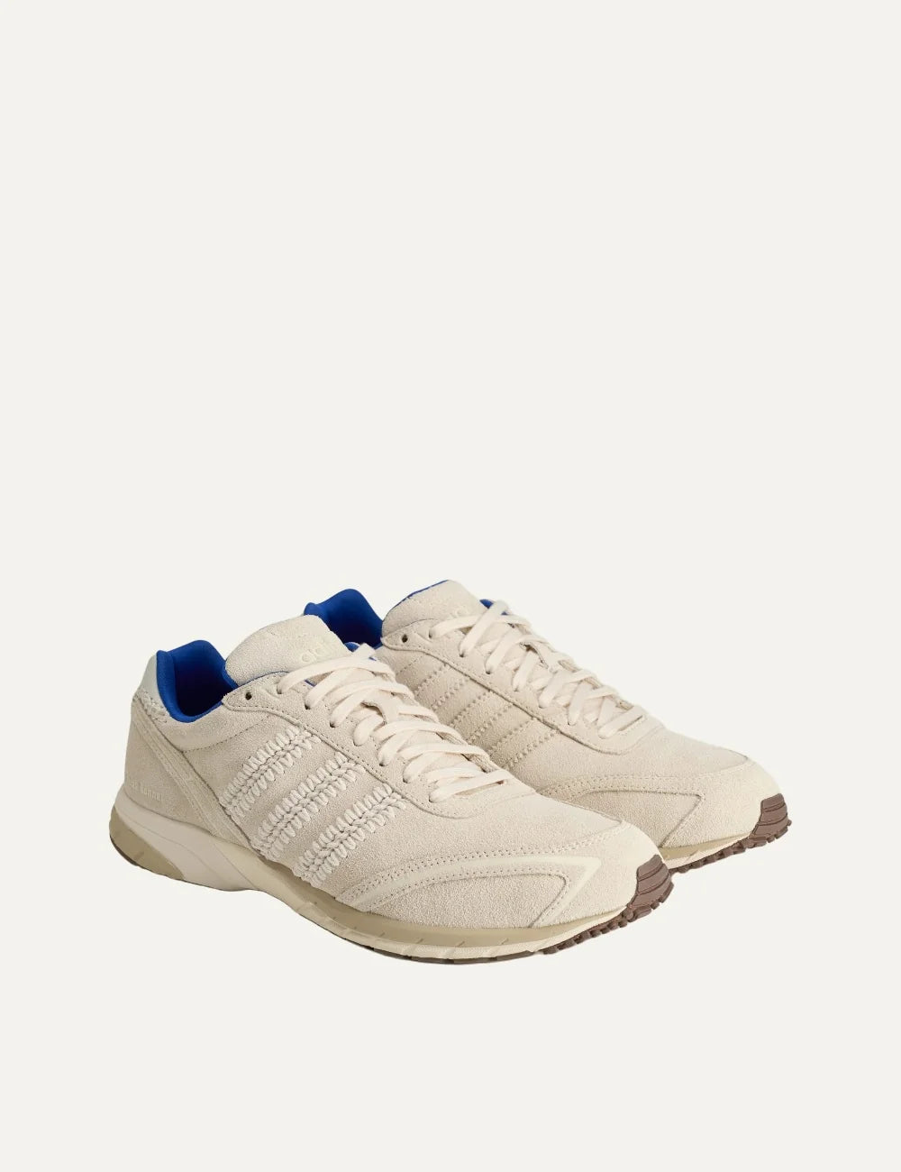 Unisex Adidas Originals x Wales Bonner Adizero Adios suede sneakers in wonder white with braided three stripes, blue accents and brown outsole, pair front angle