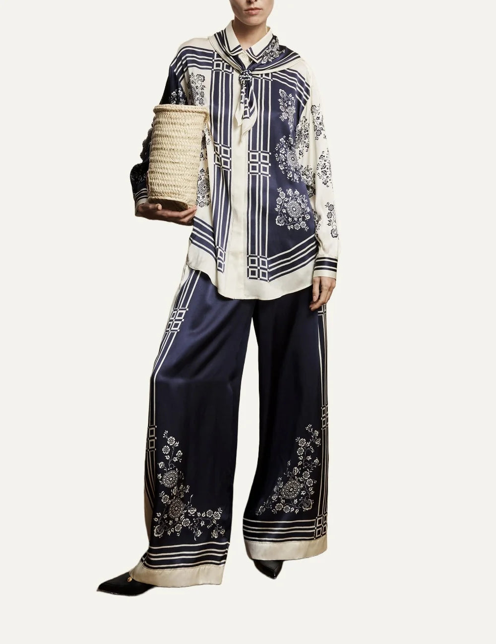 Alemais Banderra women's navy blue silk satin wide leg pants with cream floral print and striped borders at the hems full body