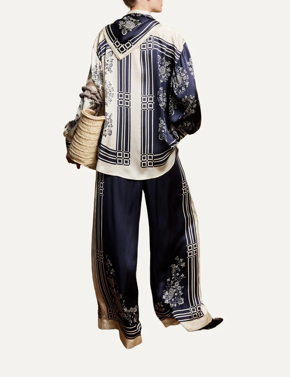 Alemais Banderra women's navy blue silk satin wide leg pants with cream floral print and striped borders at the hems back