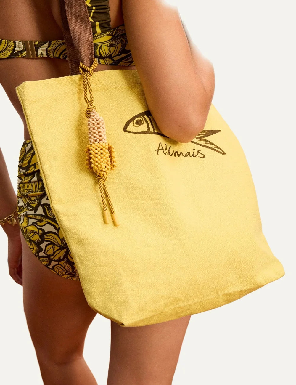 ALEMAIS Mona Banana bag charm with yellow wooden beads and striped cord model