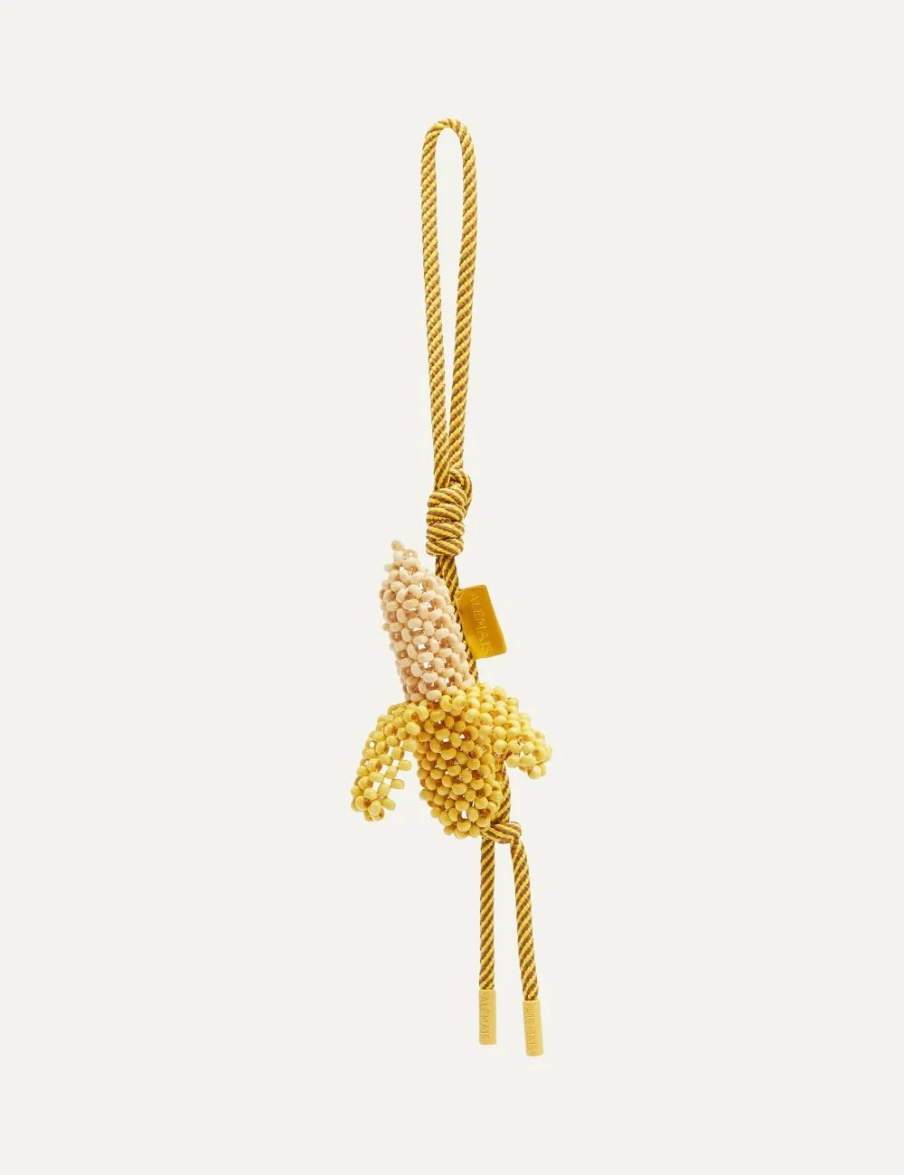 ALEMAIS Mona Banana bag charm with yellow wooden beads and striped cord