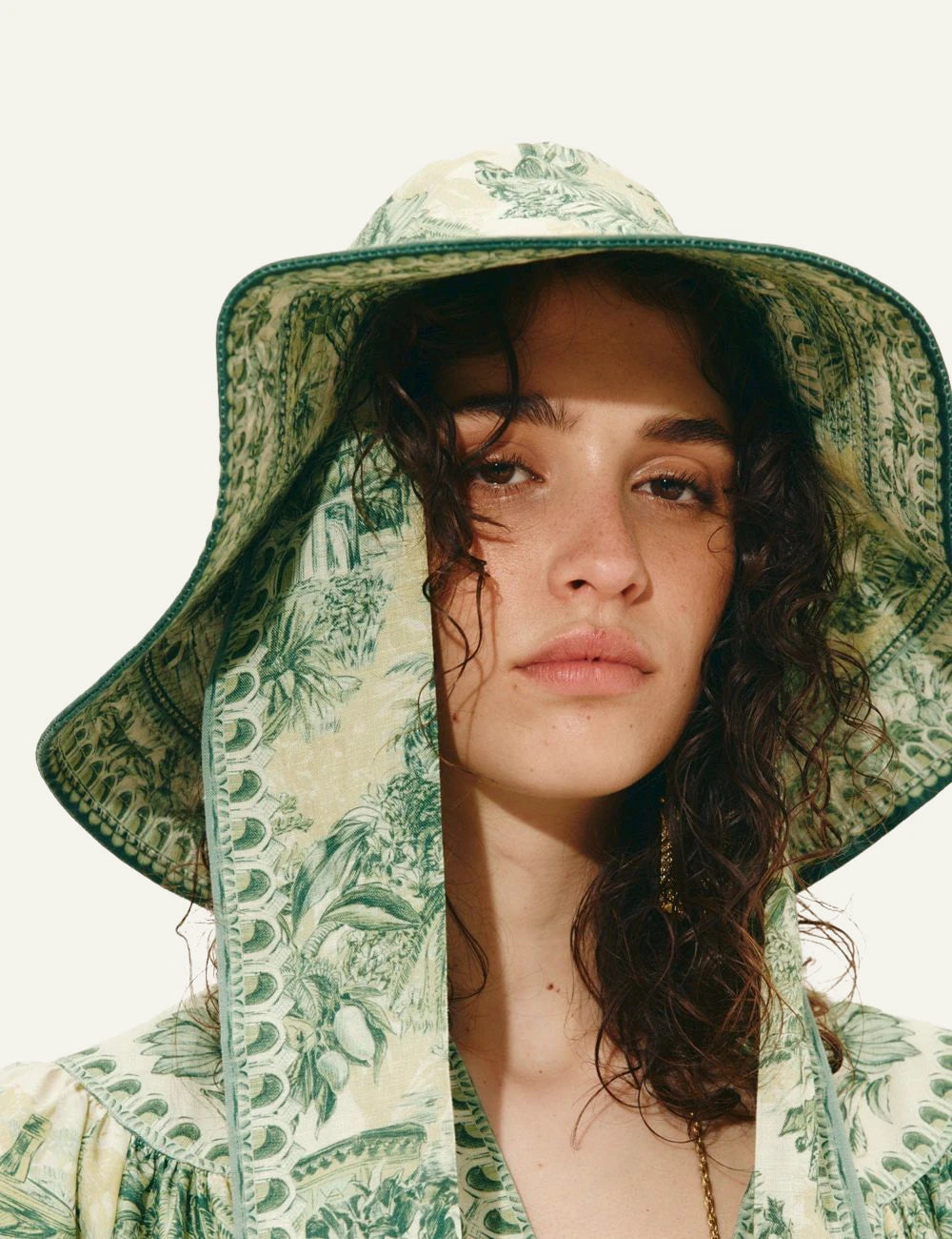 Alemais Sara linen sunhat green tropical print close up worn