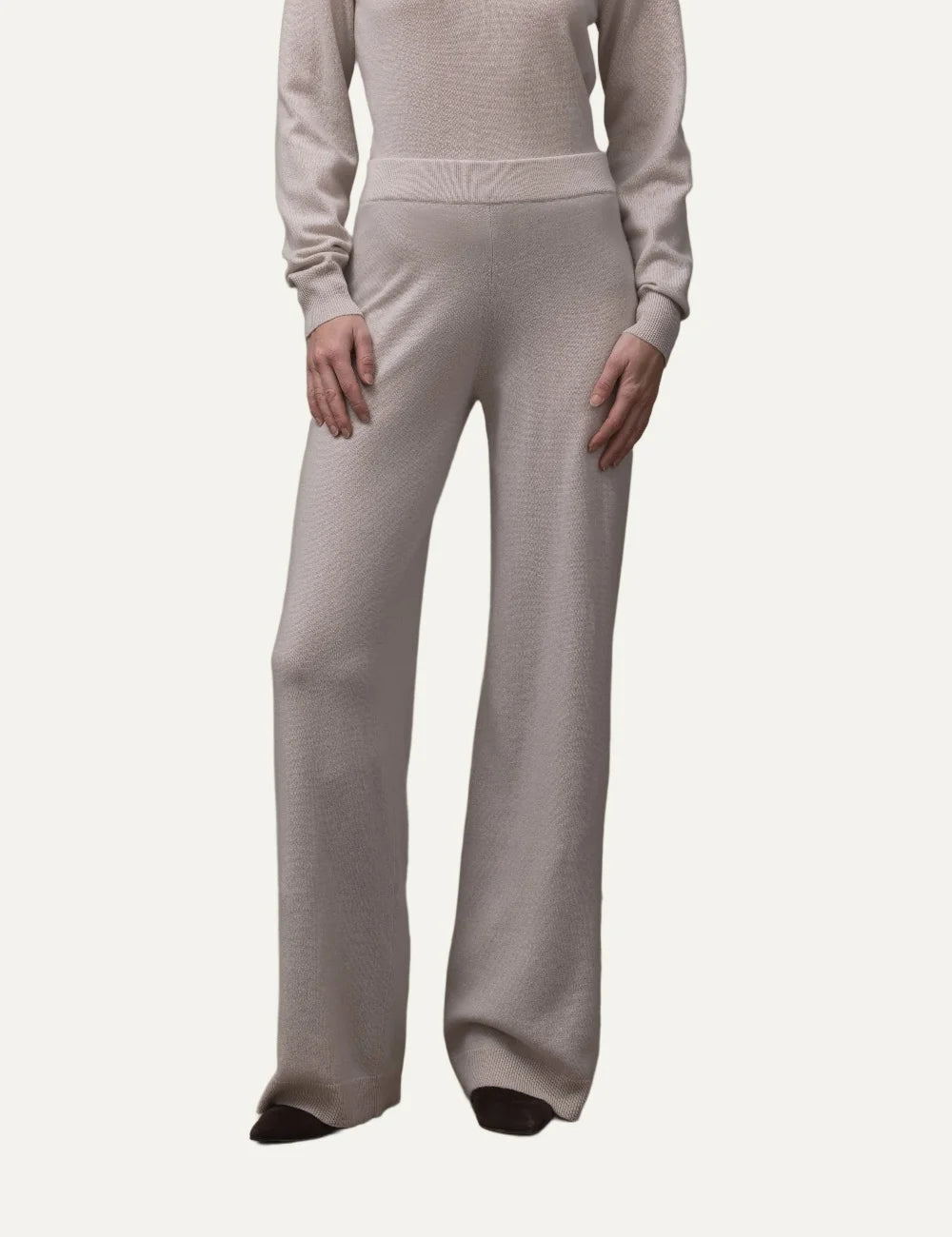 Allude women's beige wool and cashmere knit trousers with wide straight legs, elasticated ribbed waistband and ribbed hems.
