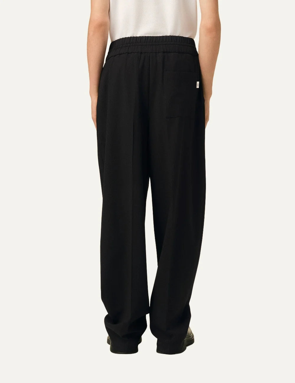 Ami Paris unisex black relaxed-fit trousers with an elasticated drawstring waist, side pockets and straight legs back