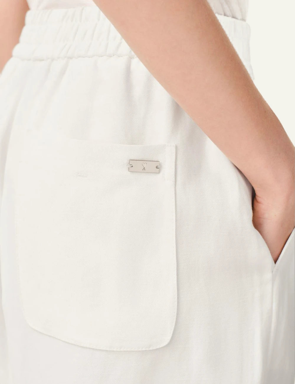 ami paris ecru straight leg trousers elastic waist front logo view