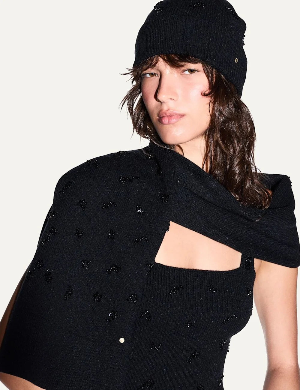 Women's Armani Exchange black knitted beanie with sequin floral details, ribbed cuff and metal plaque model