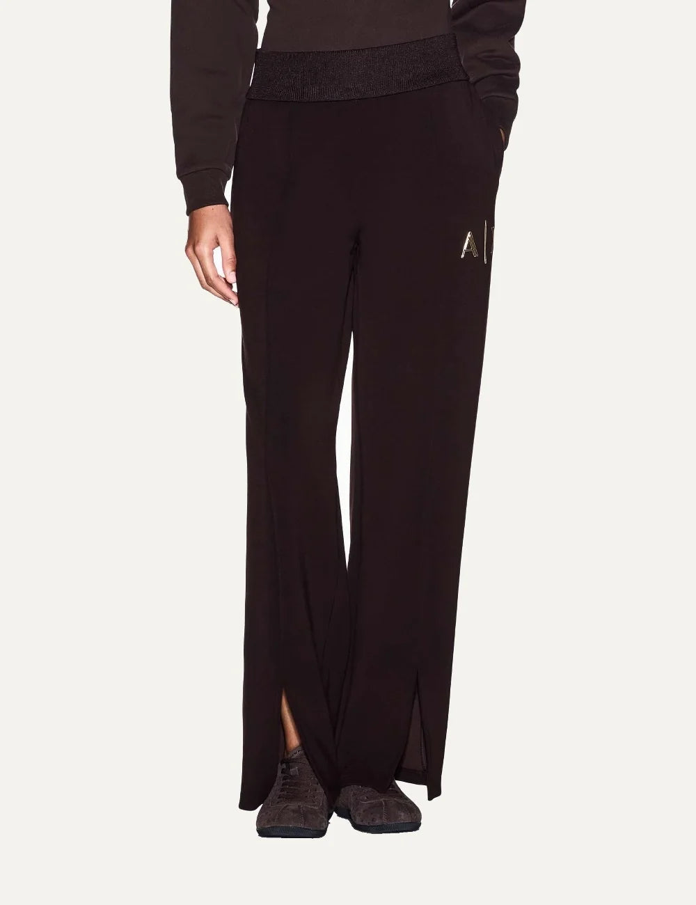 Armani Exchange women's dark brown wide-leg sweatpants with elastic waistband, A|X logo and front hem slits model
