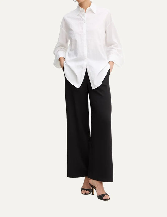 Armani Exchange women's white oversized long sleeve shirt with subtle logo jacquard pattern, classic collar and button front.
