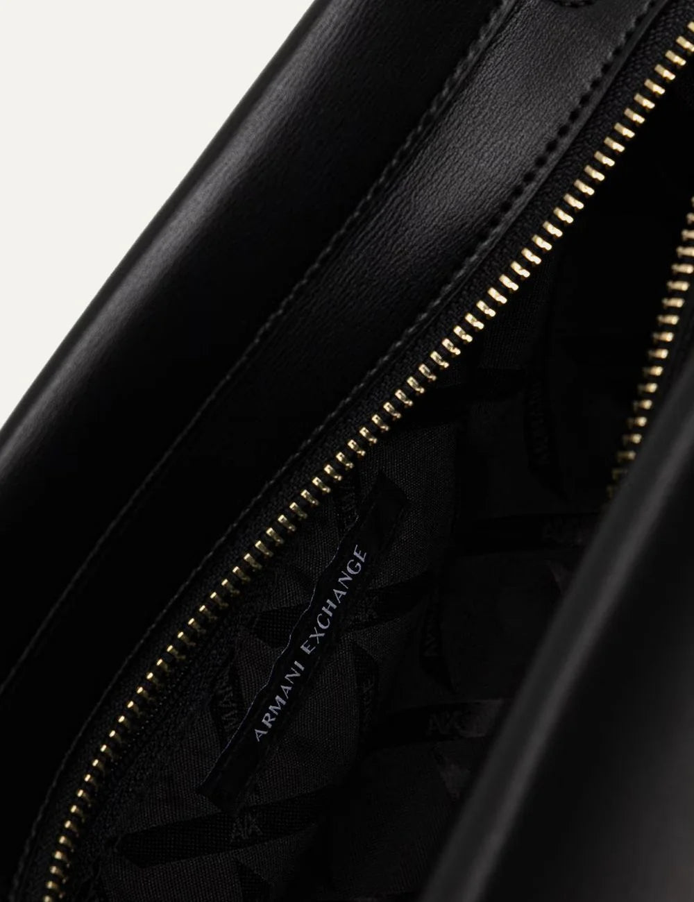 Women's Armani Exchange black shoulder bag with foldover flap, gold-tone padlock detail, front logo and adjustable shoulder strap top