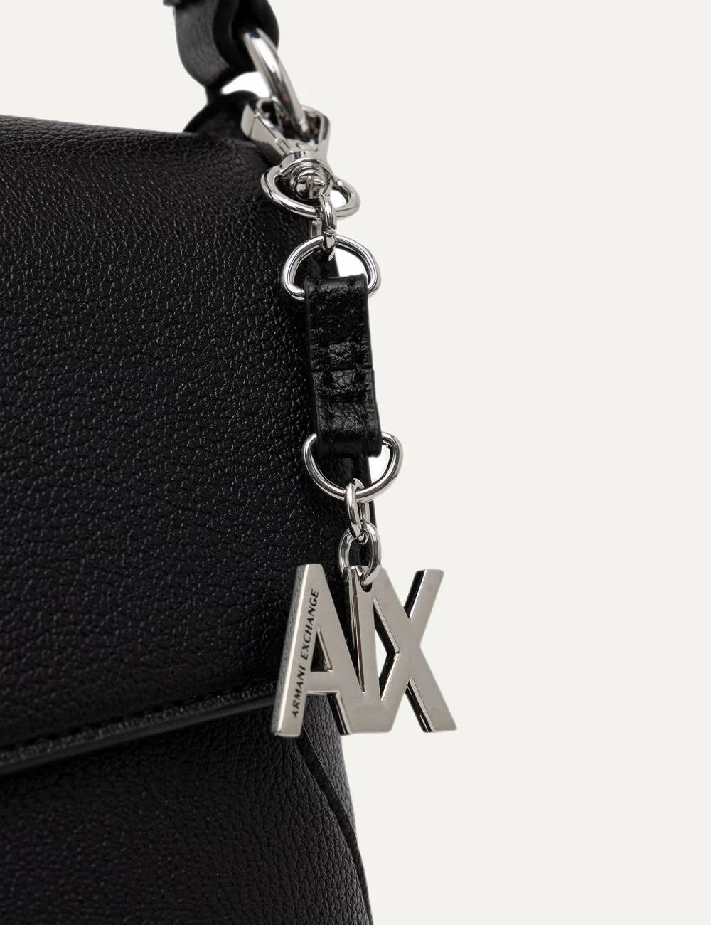 Women's Armani Exchange black shoulder bag with pebbled texture, foldover flap, silver-tone A|X logo, top handle and detachable shoulder strap detail