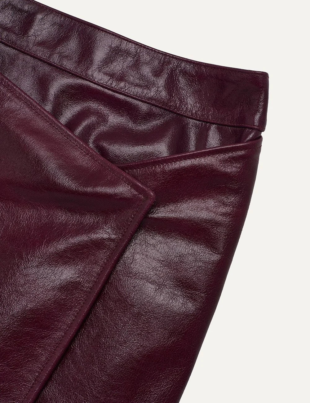 Armarium burgundy glossy leather midi skirt with asymmetric overlapping front panel and exposed zipper
