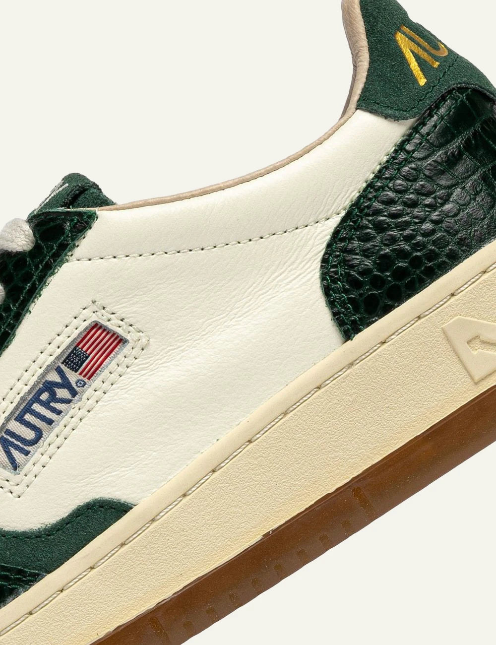 Autry women’s ivory leather sneakers with green crocodile-effect details logo