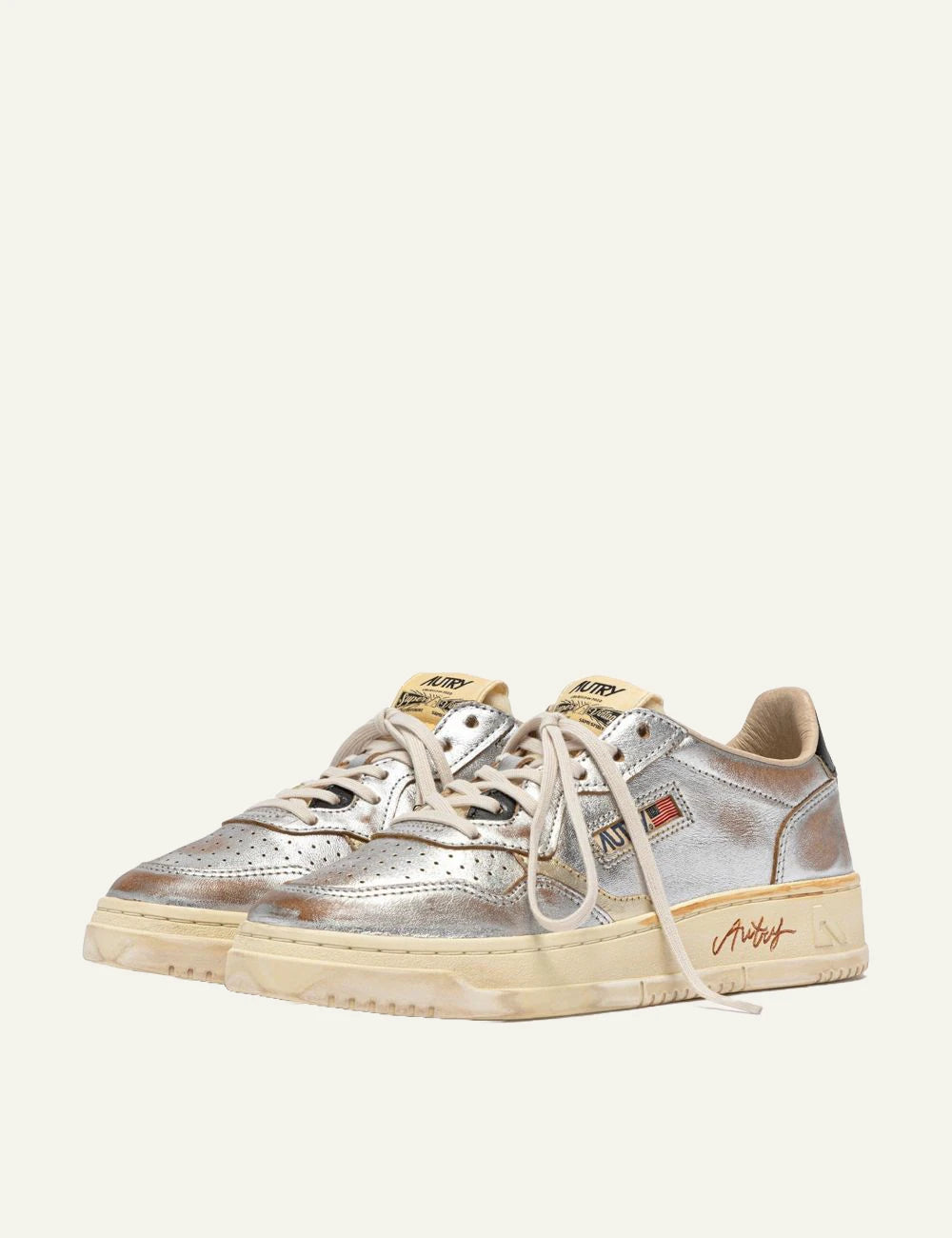 Autry women’s metallic silver leather sneakers with vintage finish profile