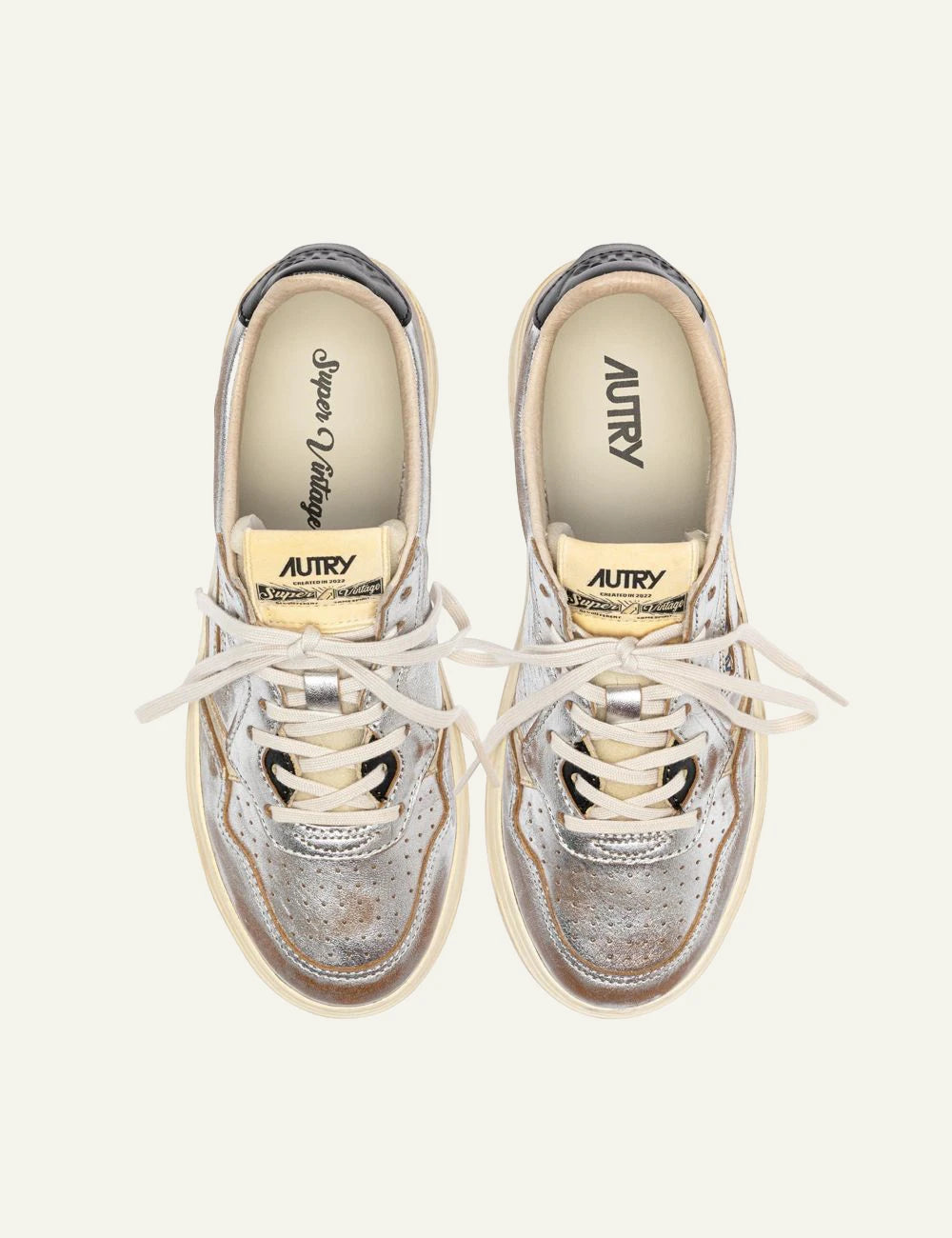 Autry women’s metallic silver leather sneakers with vintage finish top