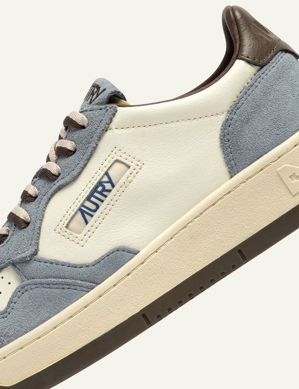 Autry women’s white leather sneakers with light blue suede and brown details logo