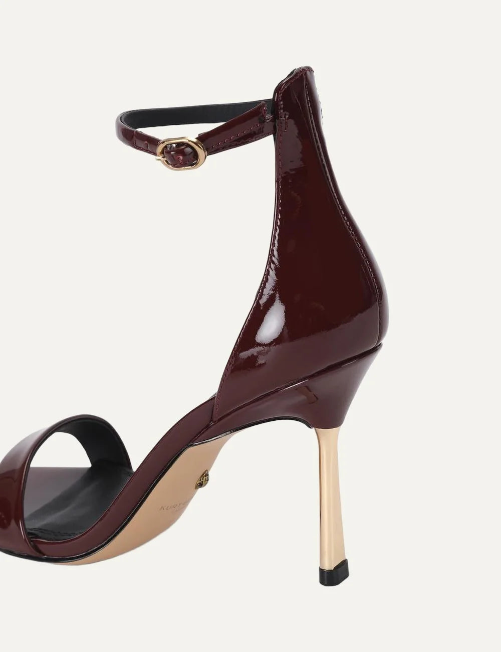 Kurt Geiger London Bank Drench wine burgundy patent leather heeled sandals with ankle strap, gold buckle and gold stiletto heel back