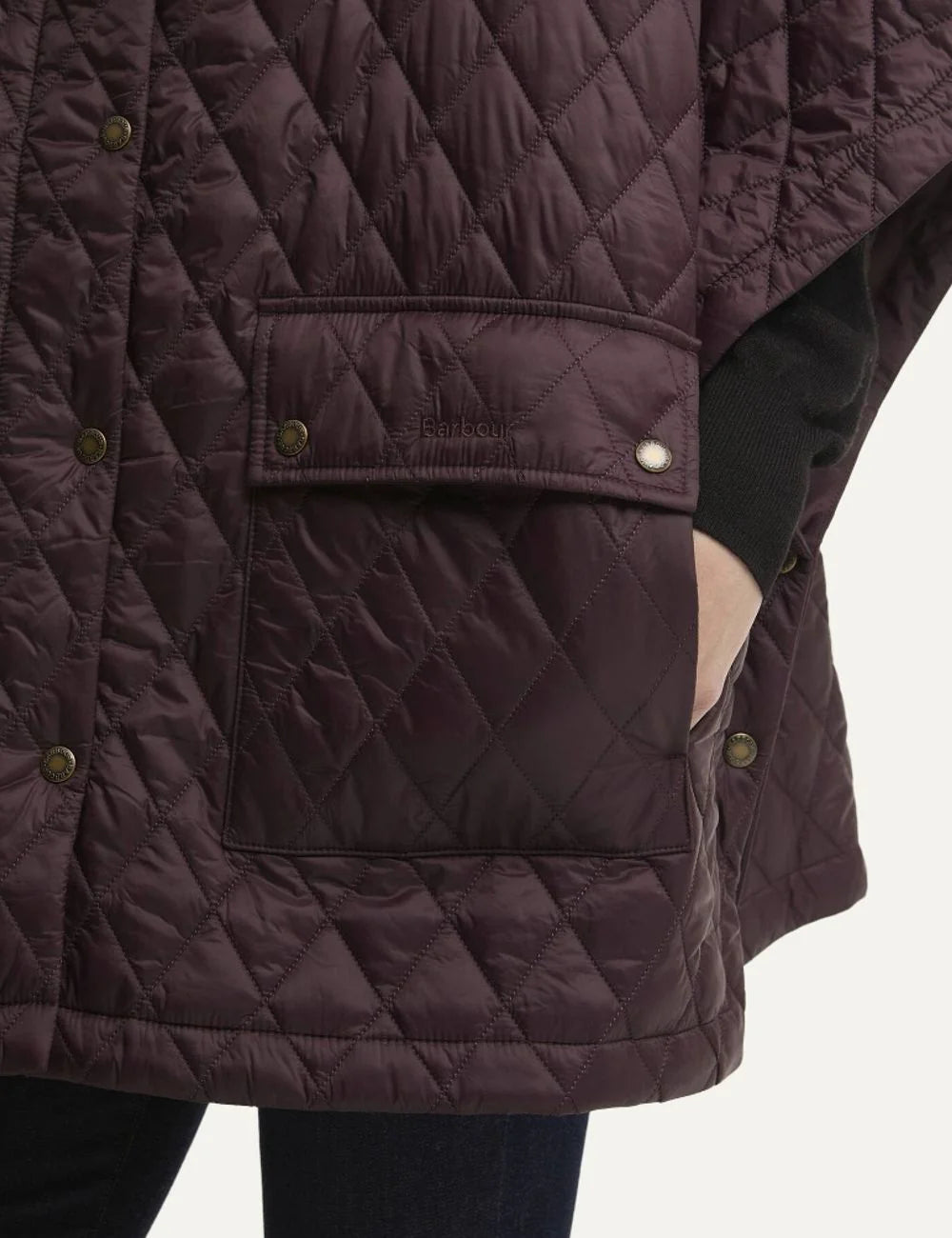 Barbour women's burgundy quilted cape with black corduroy collar snap fastening and large patch pockets pocket