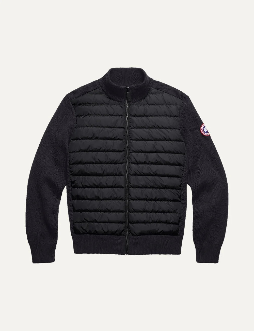 Canada Goose men's HyBridge Knit Jacket in black merino wool with down-filled quilted front, ribbed collar and cuffs, zip closure and logo patch