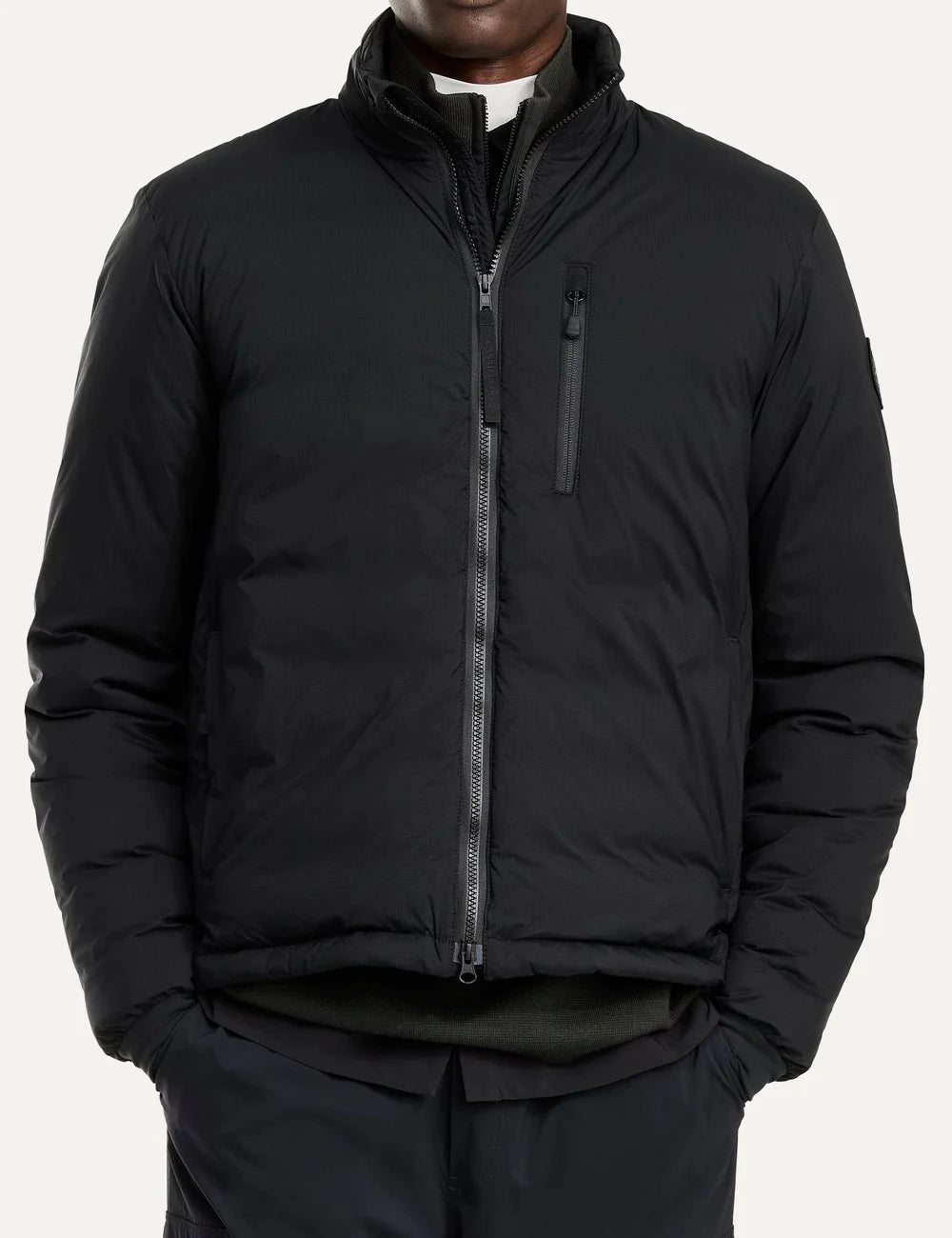Canada Goose men's Lodge Jacket in black with down insulation, stand collar, two-way zipper, zippered pockets and logo patch model