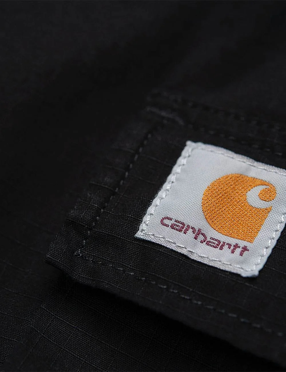 Men's Carhartt WIP Regular Cargo Pant in black ripstop with cargo pockets detail