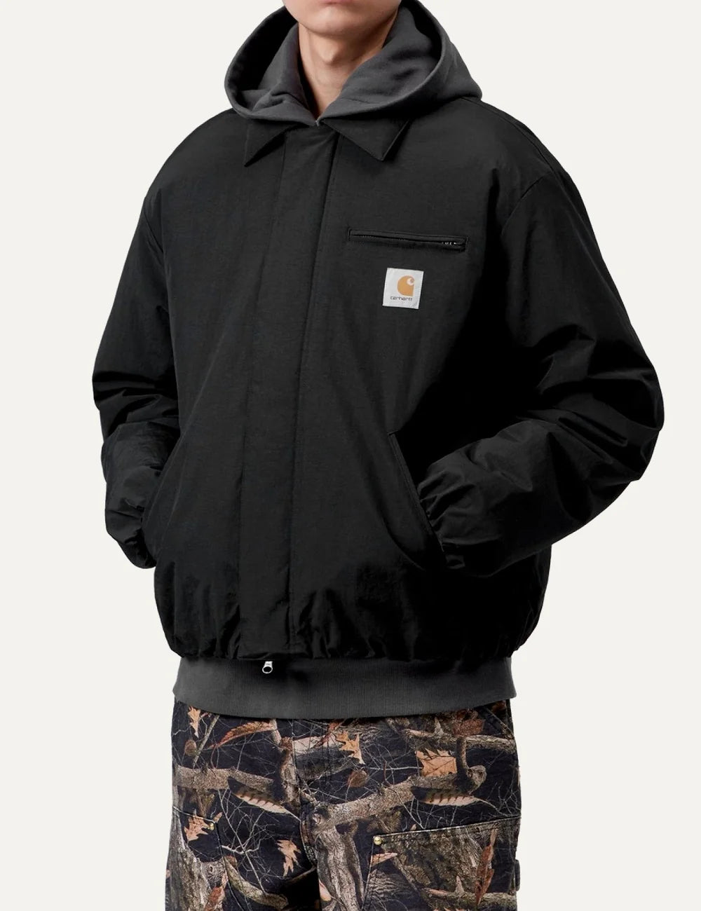 Carhartt WIP men Stanwood black water-repellent nylon jacket with chest zip pocket and logo label model