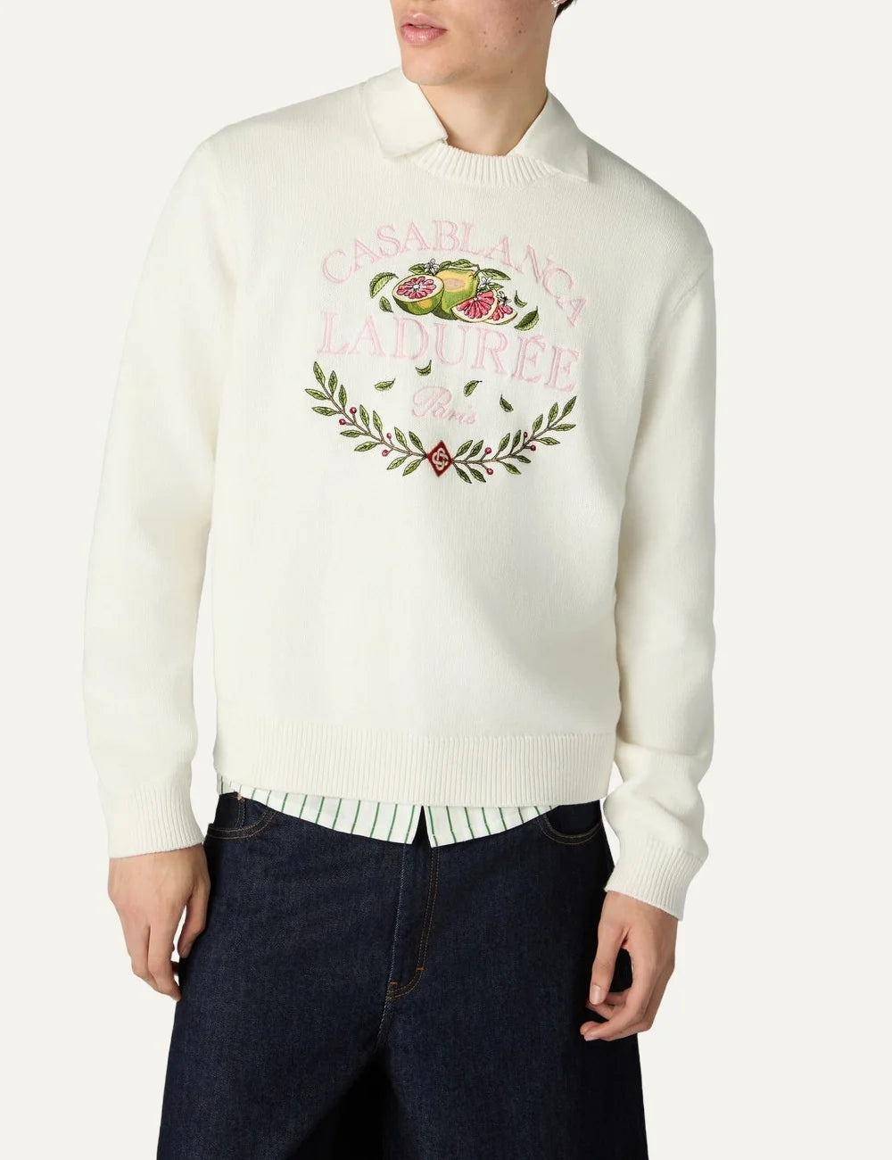Casablanca x Ladurée unisex off-white cotton knit sweater with embroidered fruit and laurel wreath artwork, pink collaboration lettering, crew neck and ribbed trims model