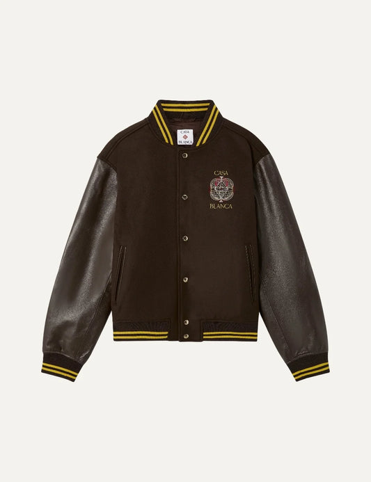 Casablanca men's brown wool varsity jacket with dark brown leather sleeves, Celestial Pyramid chest embroidery, yellow striped ribbed trims and snap-button closure.