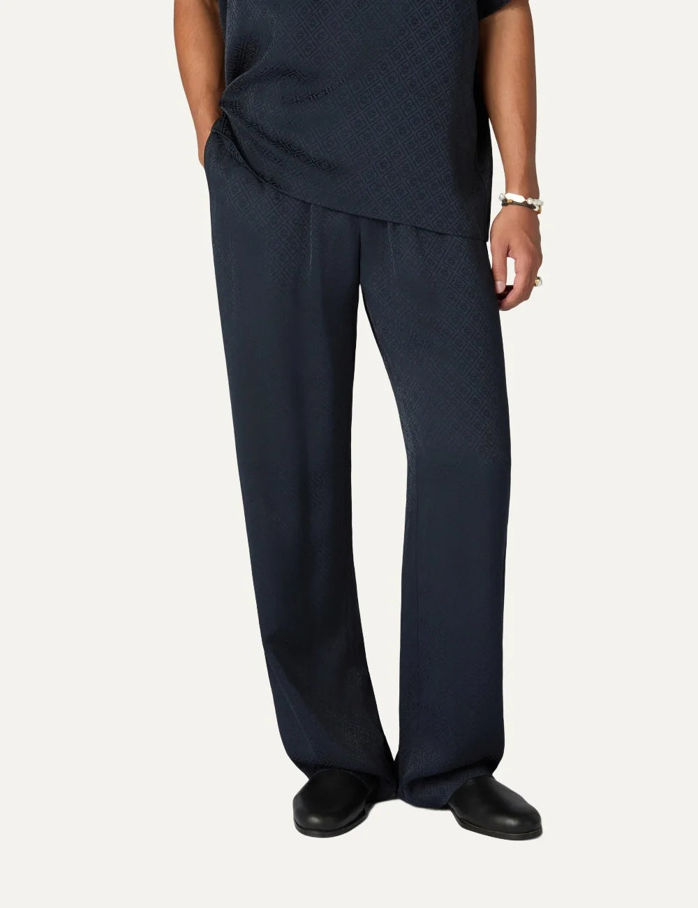 Casablanca men's dark navy monogram viscose trousers with tonal interlocking CC pattern, elastic waistband and straight legs model