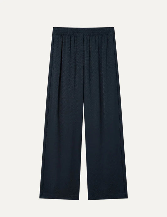 Casablanca women's navy straight-leg jacquard trousers with tonal CC monogram pattern, elastic waistband and wide-leg silhouette.