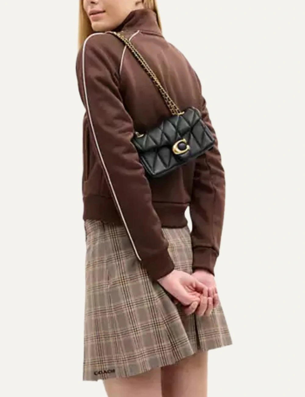 Coach Tabby 20 black quilted nappa leather shoulder bag with gold Signature C hardware and chain strap on model
