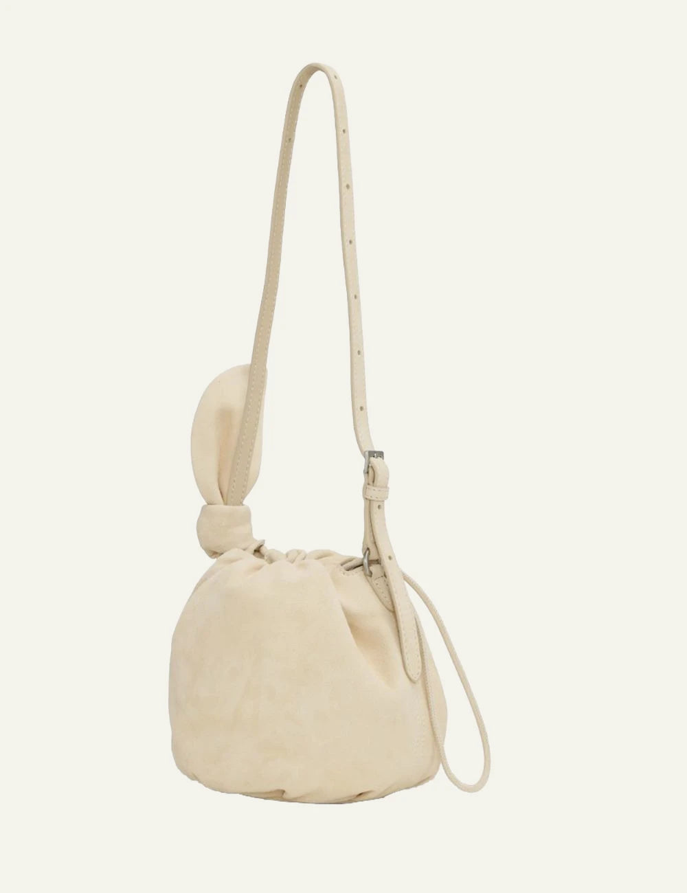 Cream leather drawstring bucket bag with shoulder strap back flat view