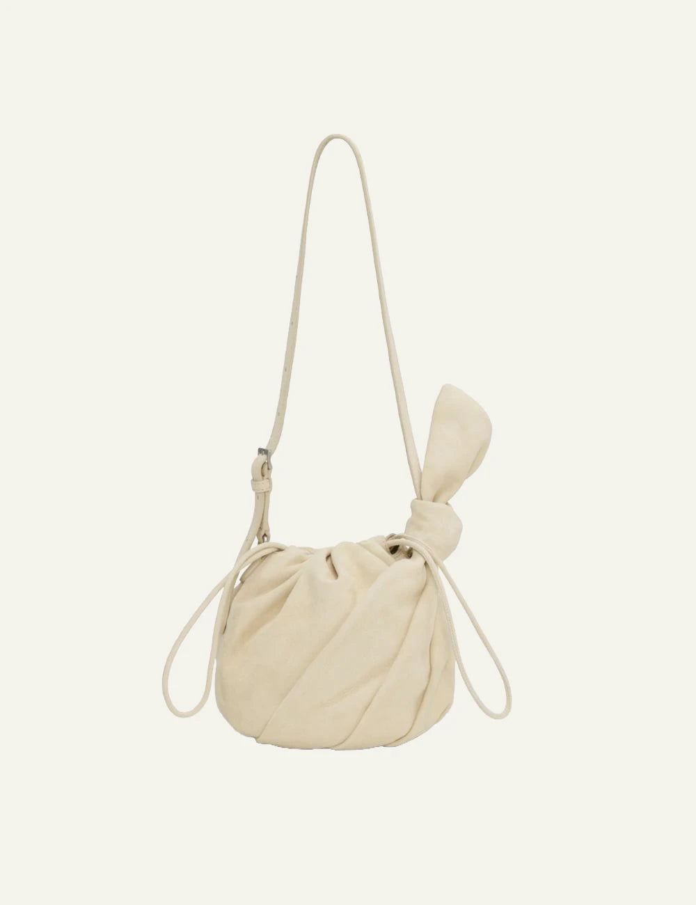 Cream leather drawstring bucket bag with shoulder strap front flat view