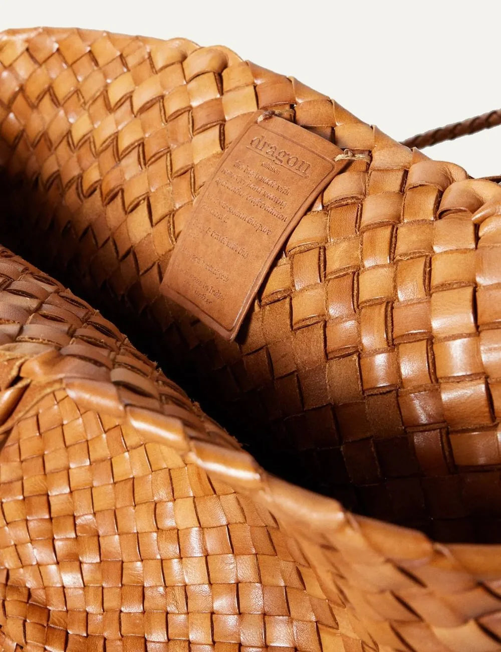 Dragon Diffusion woven leather basket bag in tan with oversized shape close up logo patch
