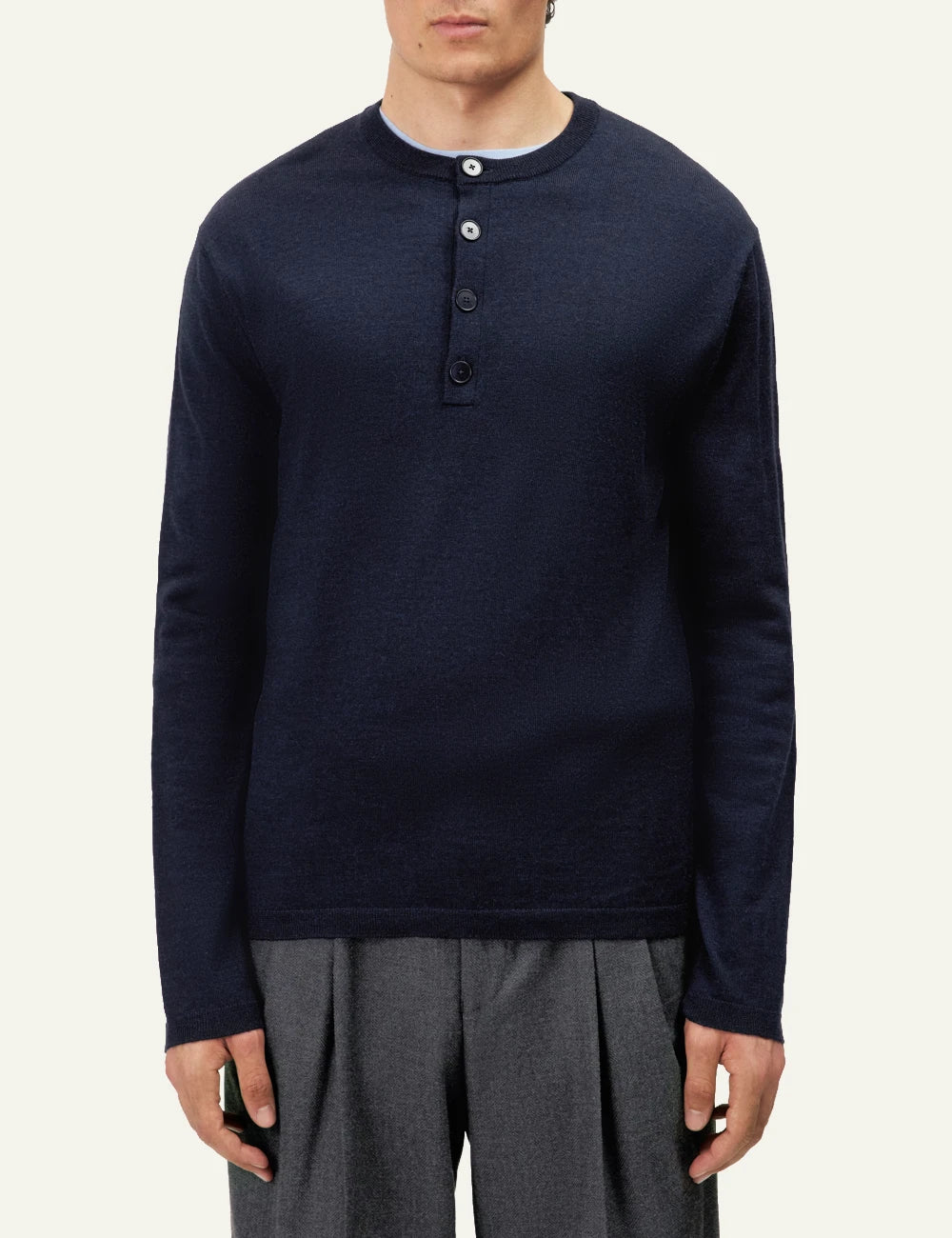 Men's DRYKORN merino wool knit sweater in dark blue with Henley button placket model