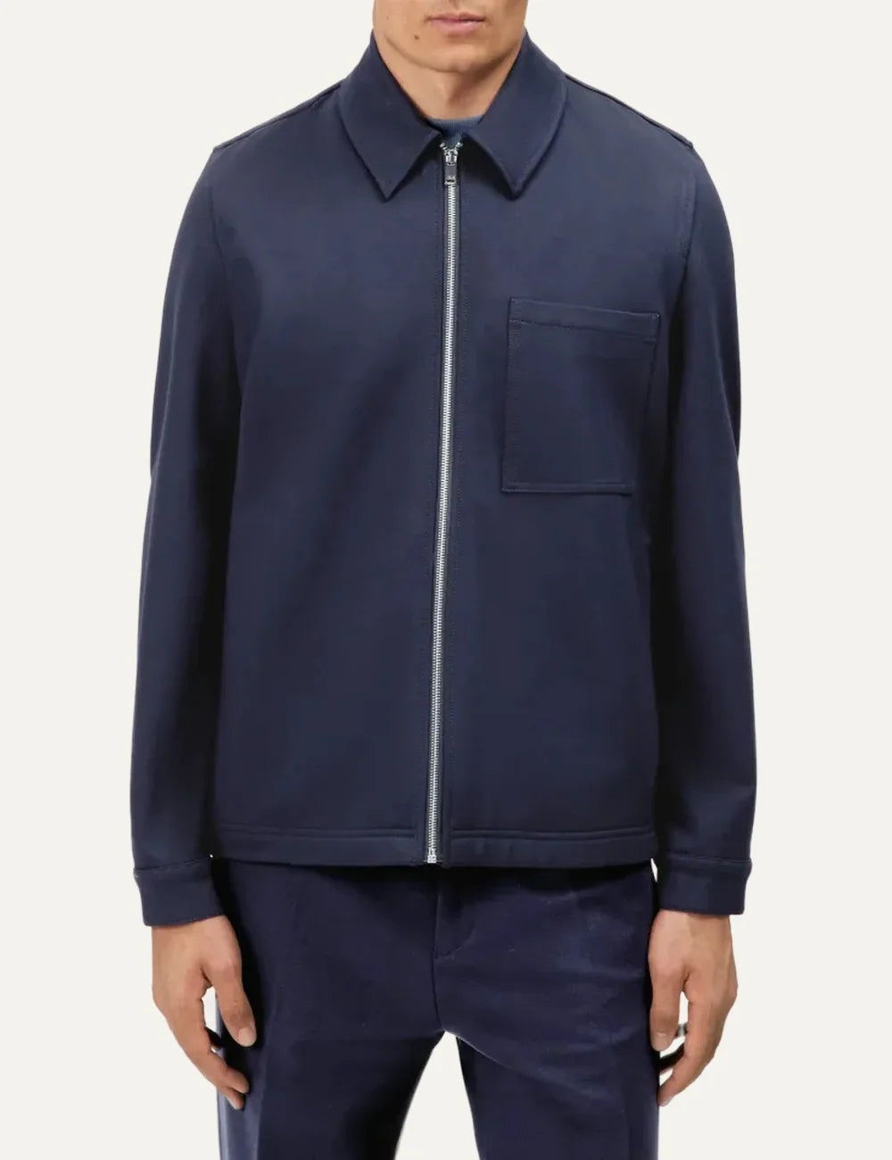 Drykorn men's navy blue Jerson zip-up jacket with a shirt collar, silver front zipper, chest patch pocket and long sleeves model