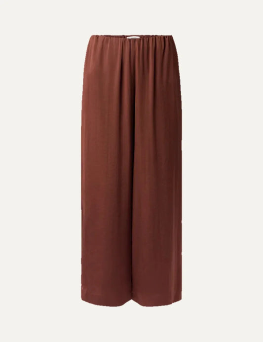 Drykorn women's terracotta satin wide-leg trousers with an elasticated gathered waistband and relaxed flowing silhouette.