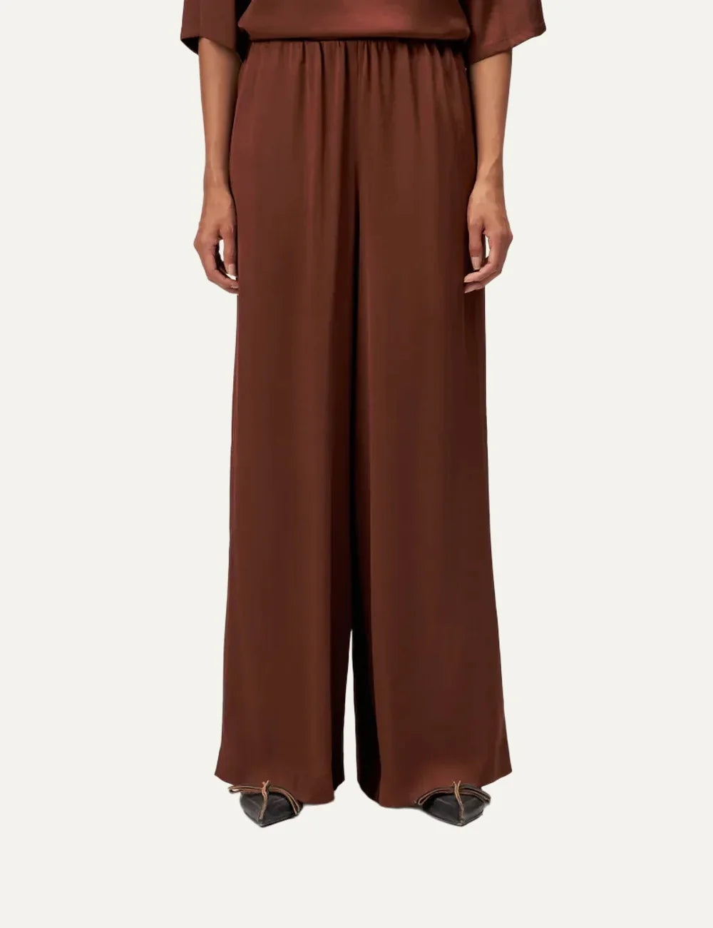 Drykorn women's terracotta satin wide-leg trousers with an elasticated gathered waistband and relaxed flowing silhouette model