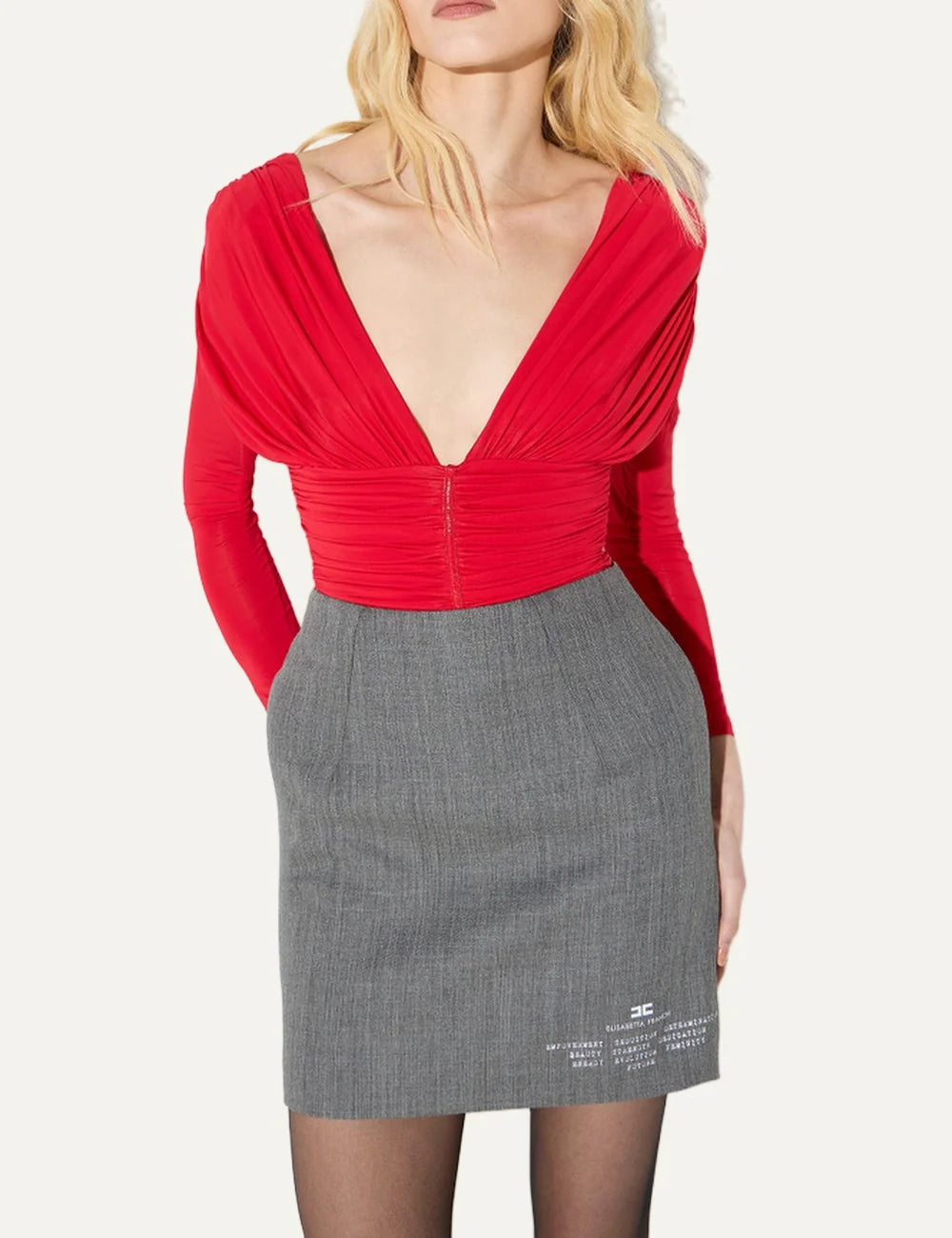 Elisabetta Franchi women's red long-sleeve bodysuit with deep V-neckline, structured draped shoulders, ruched waist and metallic-effect front detail model
