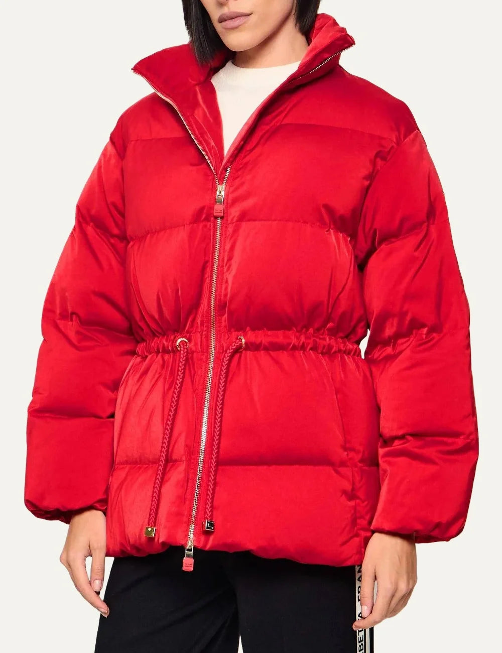 Elisabetta Franchi women's red quilted puffer jacket with a high stand collar, front zipper, long sleeves and adjustable drawstring waist.