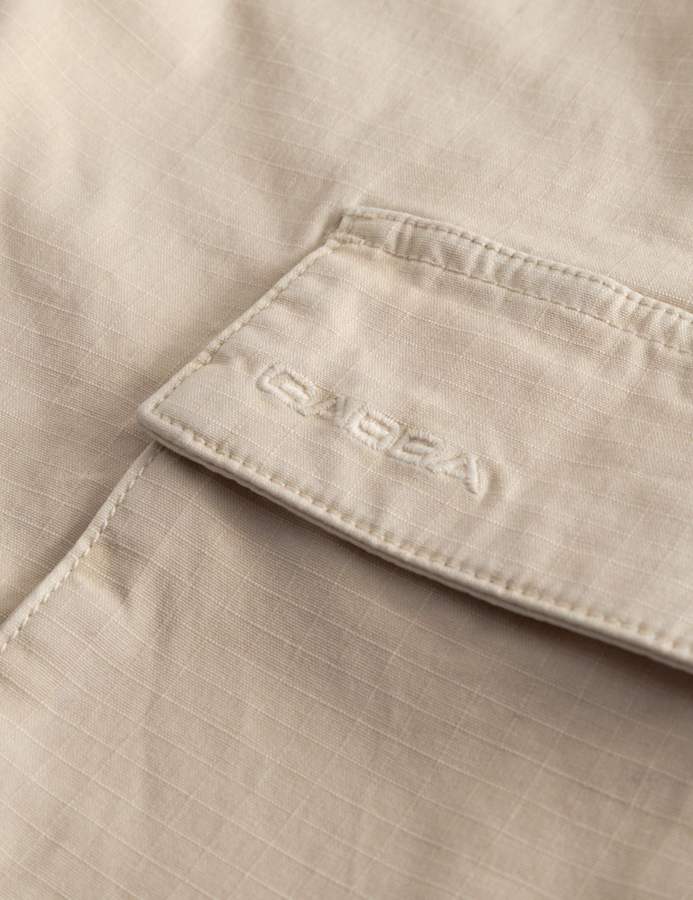 Gabba cargo shorts relaxed fit beige side pockets front logo detail view
