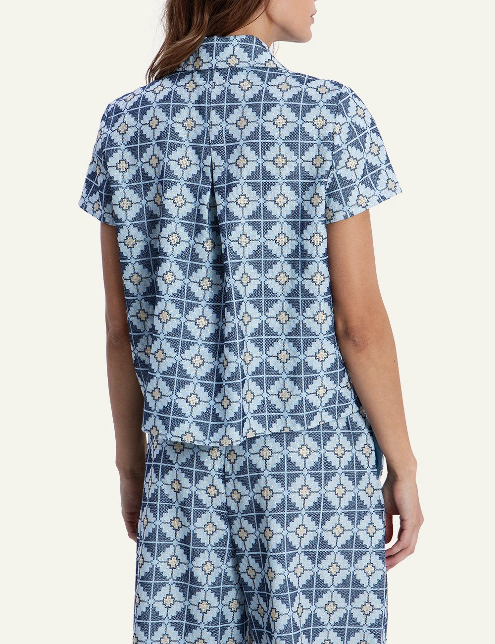 Greek Archaic Kori blue floral patterned shirt back view