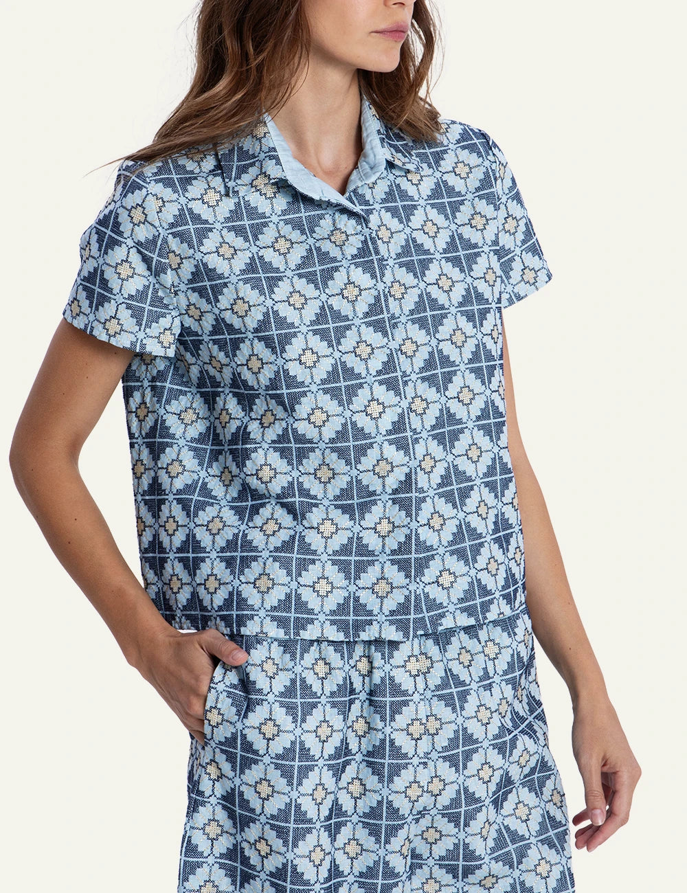 Greek Archaic Kori blue floral patterned shirt front view