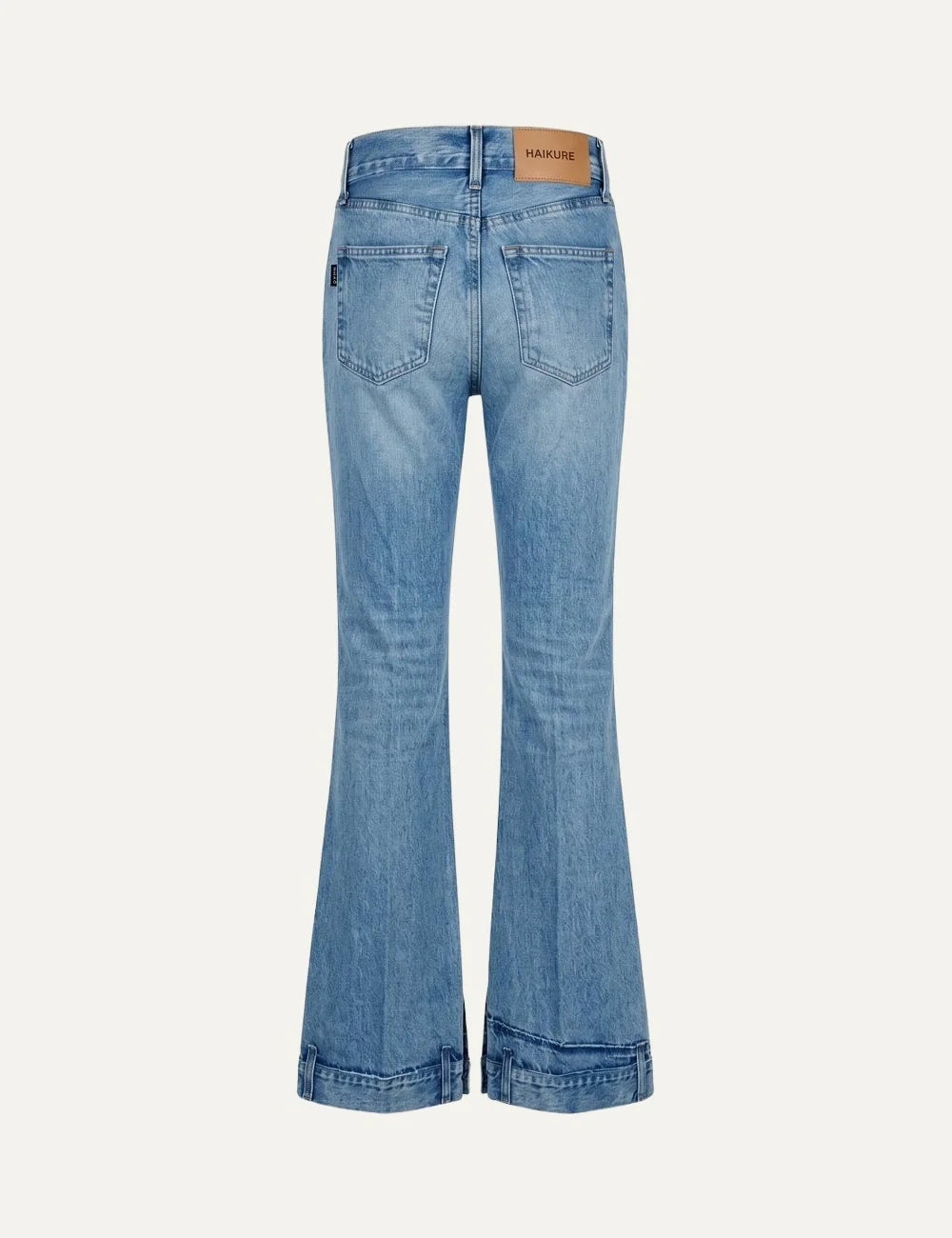 Haikure women blue washed flared jeans with distressed detail and buttoned hem straps back view
