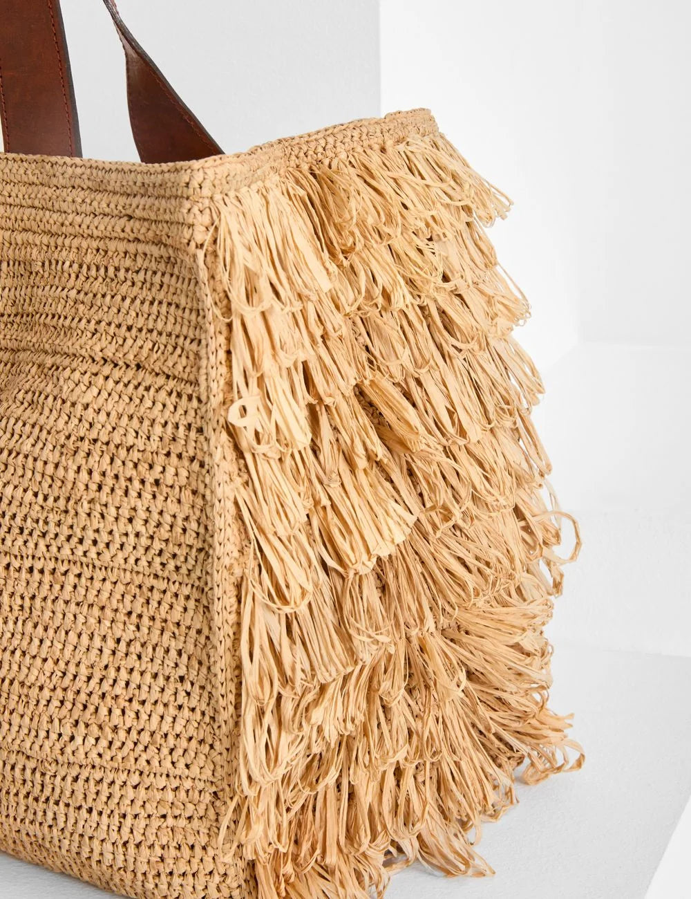 Ibeliv Onja raffia tote bag me leather handles and fringe details side view